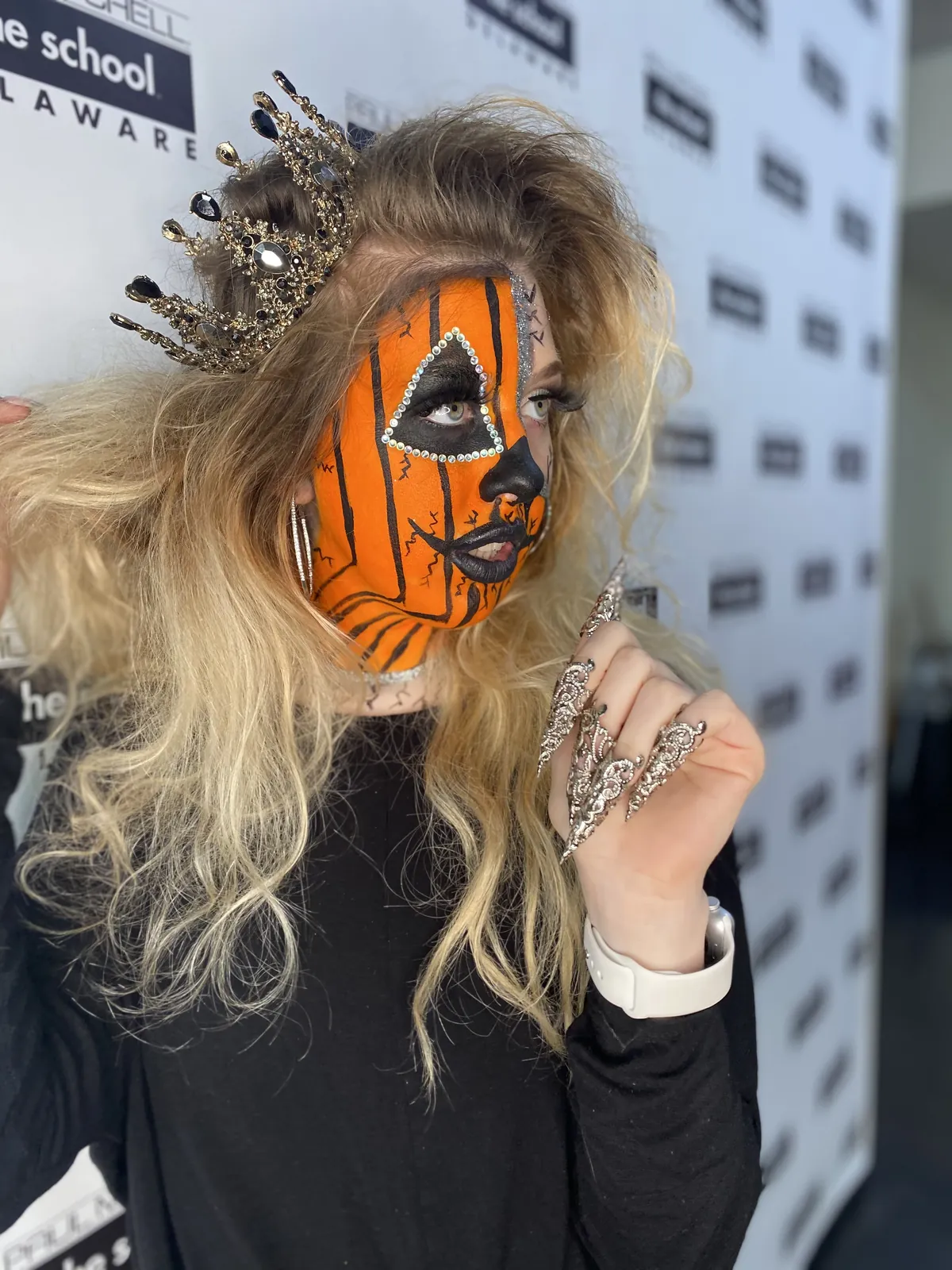 Pumpkin face paint with a jeweled crown