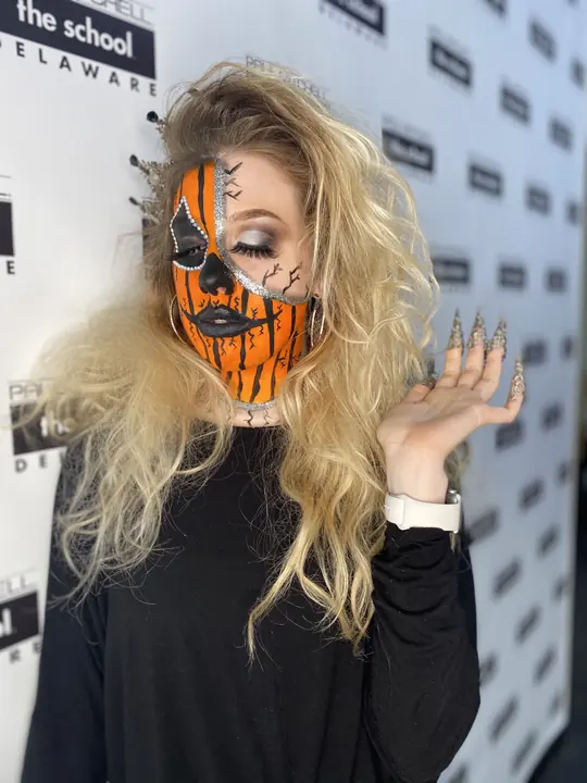 Pumpkin face paint with cracked detail and long nails