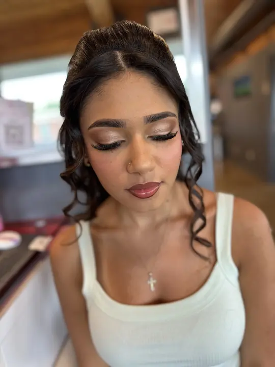 Glam with lashes and a glossy lip, curls pinned up