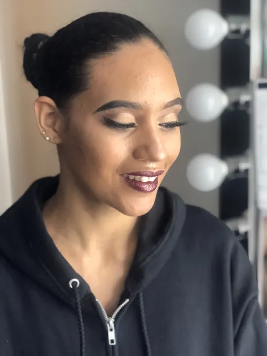 Berry lip and soft smoky eye, smiling