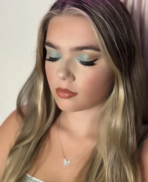 Close up of a sage eye, winged liner and glossy lip